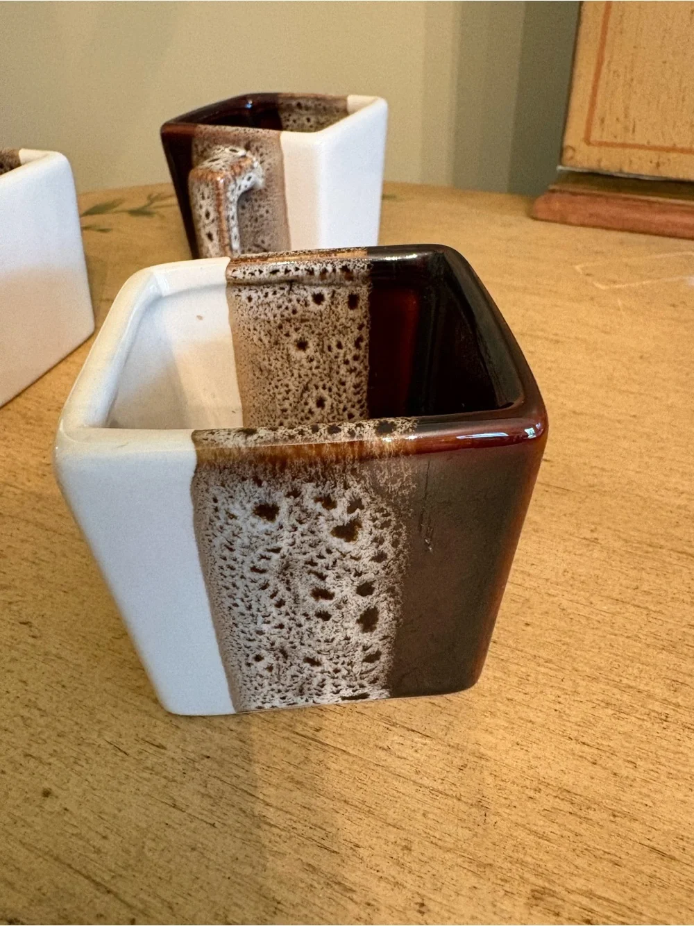 Pier 1 Imports tricolor stoneware square espresso mugs in brown, white, and tan.